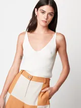 Short de lino color beige y naranja, de tiro alto con elástico en la pretina trasera, cierre delantero y botón, bolsillos delanteros y dobladillo invisible.