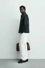 Sobrecamisa regular fit color verde oscuro, confeccionada en tejido efecto ante. Cuenta con cuello solapa, manga larga con puño abotonado, bolsillos de plastrón con solapa en el pecho y bolsillos de vivo en la cadera. El cierre es frontal con botonadura.