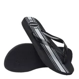 Sandalias tipo ojota Havaianas color negro con diseño de franjas verticales en gris y blanco. Presentan tiras negras con textura grabada y logo de la marca.