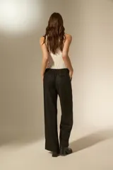 Pantalon de vestir negro con acabado brillante tipo glitter, de corte ancho y tiro alto.