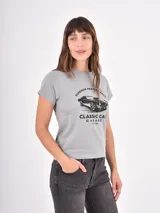 Remera gris de corte clásico con cuello redondo y mangas cortas. Presenta un estampado frontal en color negro con la ilustración de un auto clásico y la leyenda 'Superior Performance Classic Car Garage Estd 1980'.