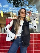 Blusa al cuerpo color blanco con estampado de lunares negros, cuello redondo y mangas largas con terminación acampanada.