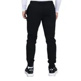 Pantalón de jogging Umbro, color azul marino, con cintura elástica y puños en los tobillos. Presenta el logo de la marca bordado en la pierna izquierda.