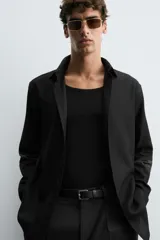 Camisa blanca de manga larga con cuello italiano y cierre frontal de botonadura. Corte regular fit.