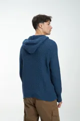 Buzo de punto color verde oliva con capucha, cordón ajustable y botones de madera en el cuello.