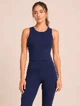 Top deportivo de cuello redondo y sin mangas, con corte ajustado y diseño minimalista. Confeccionado en tejido de algodón con lycra, ofrece gran elasticidad y suavidad.