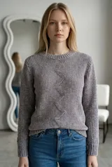 Sweater de tejido de punto chenille color beige, con cuello redondo y diseño de patrón en zigzag vertical en el centro. Presenta puños y ruedo acanalados.