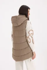 Chaleco largo acolchado con capucha ajustable, cierre frontal y bolsillos laterales con cierre.