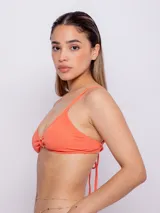 Top de bikini color naranja con textura, aro con forma de corazón en el centro, breteles finos regulables y copas desmontables.
