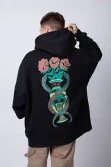 Buzo tipo canguro de corte oversize, color blanco, con capucha y cordones ajustables. Presenta un pequeño estampado de una rosa roja en el pecho y un bolsillo frontal tipo canguro.