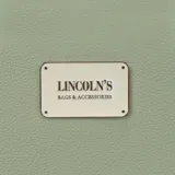 Billetera larga con cierre perimetral, confeccionada en material sintético texturizado color mostaza. Cuenta con correa de mano extraíble y placa metálica con logo de la marca en el frente.