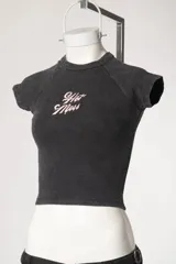 Remera de morley con efecto lavado y mangas raglán, de color negro, corte ajustado al cuerpo y aplique frontal con la inscripción "Hot Mess".