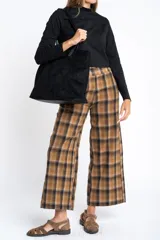 Polera de manga larga color marrón jaspeado, con cuello alto y corte ajustado al cuerpo.