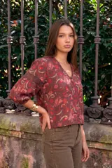 Blusa estampada de manga larga color bordó, confeccionada en viscosa, con escote en V y detalles de encaje en el cuello y las mangas.