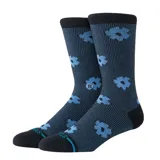 Medias de caña alta Stance modelo Digital Daisy Crew, color negro con diseño de margaritas celestes en tejido jacquard. Cuentan con puntera y talón reforzados en color negro.