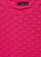 Buzo de tejido calado color fucsia, con cuello redondo y manga corta. Presenta un diseño de punto con textura geométrica y terminaciones acanaladas.
