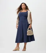 Vestido midi evasé de color azul marino, confeccionado en bengalina. Presenta escote cuadrado, diseño sin mangas, recortes verticales estructurados y una falda amplia.