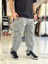 Pantalón cargo de jean azul con múltiples bolsillos en los laterales y diseño holgado.
