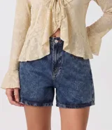 Short mom de jean azul con tiro alto, cintura con trabillas, bolsillos delanteros y traseros, y lavado con efecto desteñido.
