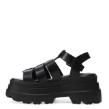 Sandalias tipo franciscanas color negro con diseño de tiras entrecruzadas, cierre con hebilla lateral y plataforma robusta con suela tractorada.