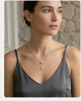 Collar doble de plata 925, compuesto por una cadena fina con un dije de circonia circular y otra cadena con un dije de estrella de plata.