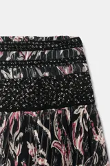 Falda corta de estilo globo, confeccionada en tejido estampado con hilo metalizado y detalles de lentejuelas. Presenta cintura elástica con nido de abeja y bajo abullonado con elástico interior.
