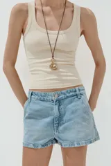 Shorts de denim de tiro medio, color celeste claro lavado, con trabillas, bolsillos laterales y bolsillos de plastrón en la espalda. Cierre frontal con cremallera y botón metálico.