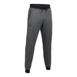 Pantalón de jogging Under Armour, color gris jaspeado, con cintura elástica ajustable con cordón, puños elásticos en los tobillos y bolsillos laterales con cierre. Presenta el logo de la marca estampado en la pierna derecha.
