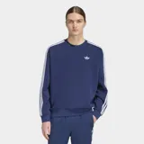 Buzo Adidas de cuello redondo con corte holgado, color azul marino. Presenta las icónicas tres rayas blancas en los hombros y mangas, y el logo del trifolio bordado en el pecho.
