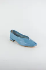 Mocasines de cuero metalizado color gris, con diseño de punta cuadrada y costura central fruncida en la capellada.