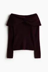 Buzo de punto acanalado con escote off-the-shoulder y detalle de nudo frontal. Presenta un diseño ajustado de manga larga y bajo recto.