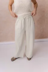 Pantalón de denim liviano color crudo, con calce amplio de pierna recta y tiro medio. Cuenta con cintura elastizada, cordón ajustable con patrón chevron, bolsillos laterales y costuras verticales delanteras que estilizan la silueta.