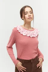 Remera de manga larga en tejido acanalado color rosa viejo, con un cuello redondo decorado con un volado amplio en color rosa claro que simula un collar.