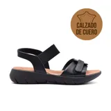 Sandalia plana de cuero negro con tiras cruzadas en el empeine, tira elástica en el talón y suela anatómica de goma.