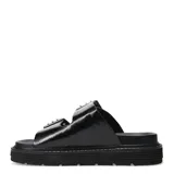 Sandalias de plataforma plana Miss Carol modelo Mavic, color negro, de estilo chunky con dos tiras anchas en el empeine decoradas con hebillas metálicas y ojales plateados.