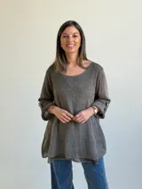 Sweater de punto color marrón chocolate, con escote redondo, mangas tres cuartos con trabilla y botón, y diseño holgado y acampanado.