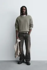 Jersey de corte relajado confeccionado en tejido de algodón con textura de canalé. Presenta cuello redondo, manga larga y un acabado con efecto lavado, con terminaciones en rib en cuello, puños y bajo.