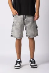 Bermuda de jean con lavado ácido, corte mom y estilo carpintero con bolsillos laterales utilitarios.