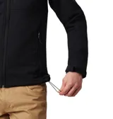 Campera softshell Columbia modelo Ascender, color negro, con tecnología Omni-Shield repelente al agua y cortavientos. Presenta cuello alto con protector de mentón, cierre frontal completo, bolsillo en el pecho y bolsillos laterales con cremallera, además de puños y dobladillo ajustables.
