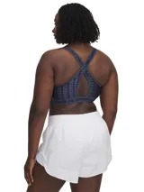 Top deportivo Under Armour con estampado abstracto en tonos de azul y gris. Cuenta con breteles anchos cruzados en la espalda y banda elástica con el logo de la marca.