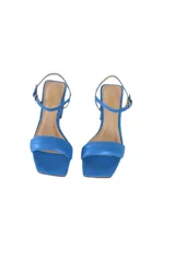 Sandalias de tacón bloque color azul satinado, con tira ancha en la parte delantera y pulsera ajustable al tobillo.