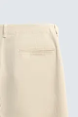Pantalón chino regular fit de color negro, confeccionado en tejido de algodón. Cuenta con bolsillos frontales, detalle de bolsillo cerillero, bolsillos traseros de doble vivo y cierre frontal con cremallera y botón.