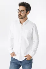 Camisa blanca de piqué, 96% algodón y 4% spandex, de manga larga y corte clásico.