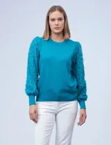 Buzo de tejido de hilado fino color celeste, marca Zac & Rachel. Mangas largas de gasa con bordado desflecado.