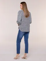 Blusa de manga larga abullonada con estampa geométrica en blanco y negro, escote redondo y puños anchos.