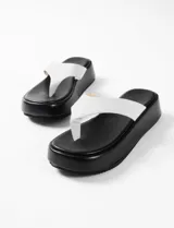 Sandalias negras con plataforma y tira ancha sobre el empeine.