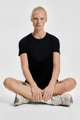 Remera deportiva negra de corte ajustado, cuello redondo y mangas raglán cortas. Confeccionada en tejido funcional DryMove™ que ayuda a absorber el sudor.