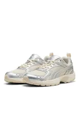 Championes deportivos Puma modelo Milenio Tech LT, en color beige con detalles metalizados en tono plateado. Cuenta con diseño de malla transpirable, cordones al tono y suela robusta con amortiguación.