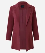 Blazer de sastrería color bordó, de corte oversized y largo, confeccionado en crepé. Presenta solapas clásicas, bolsillos frontales y detalle de pliegues en los puños.