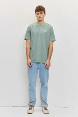 Remera verde militar de manga corta, con cuello redondo y pequeño estampado tipográfico blanco en el pecho.